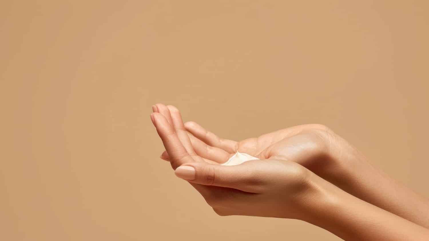 Close-up of hands applying CO2Lift Carboxy Mousse to reduce wrinkles on hands and improve skin elasticity.